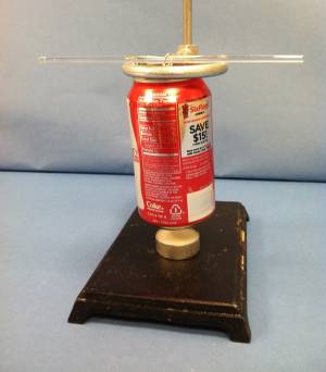 A soda can setup about 2cm ovr a candle that is not lit.